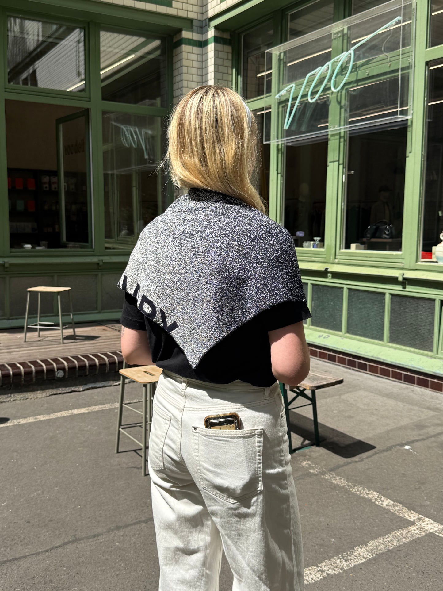 Woman wearing a scarf at a cafe