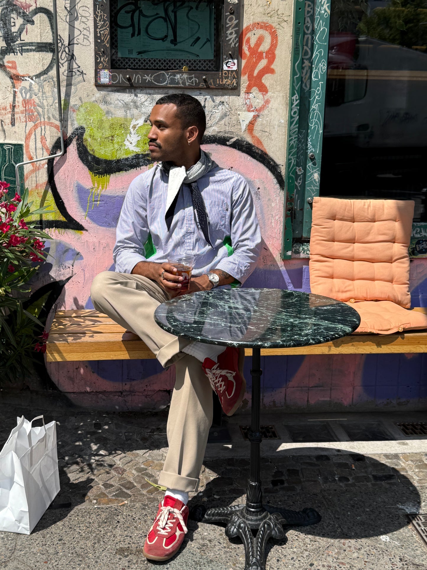 Man sitting at cafe wearing scarf